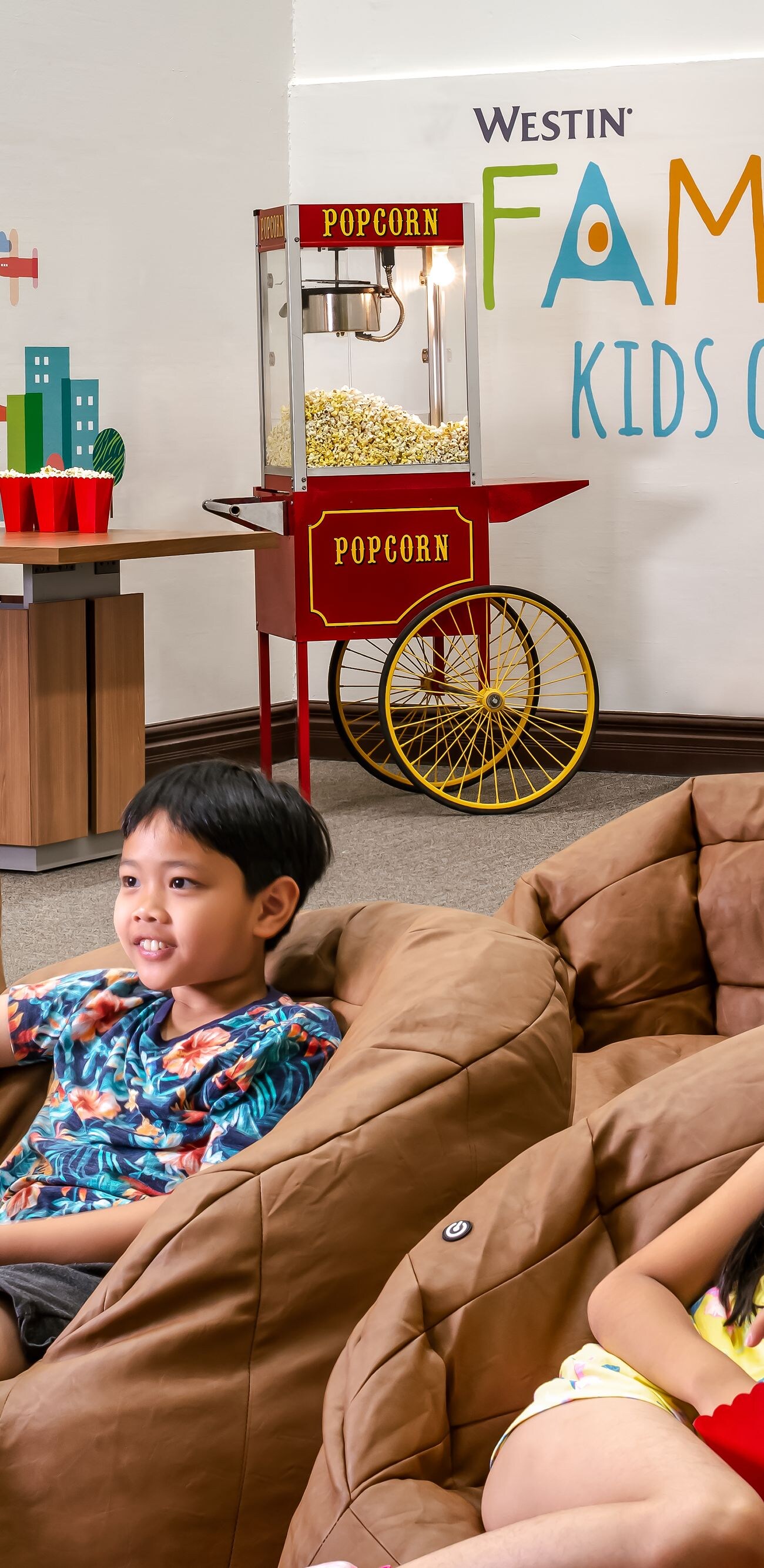 kids enjoying a movie in the westin family club