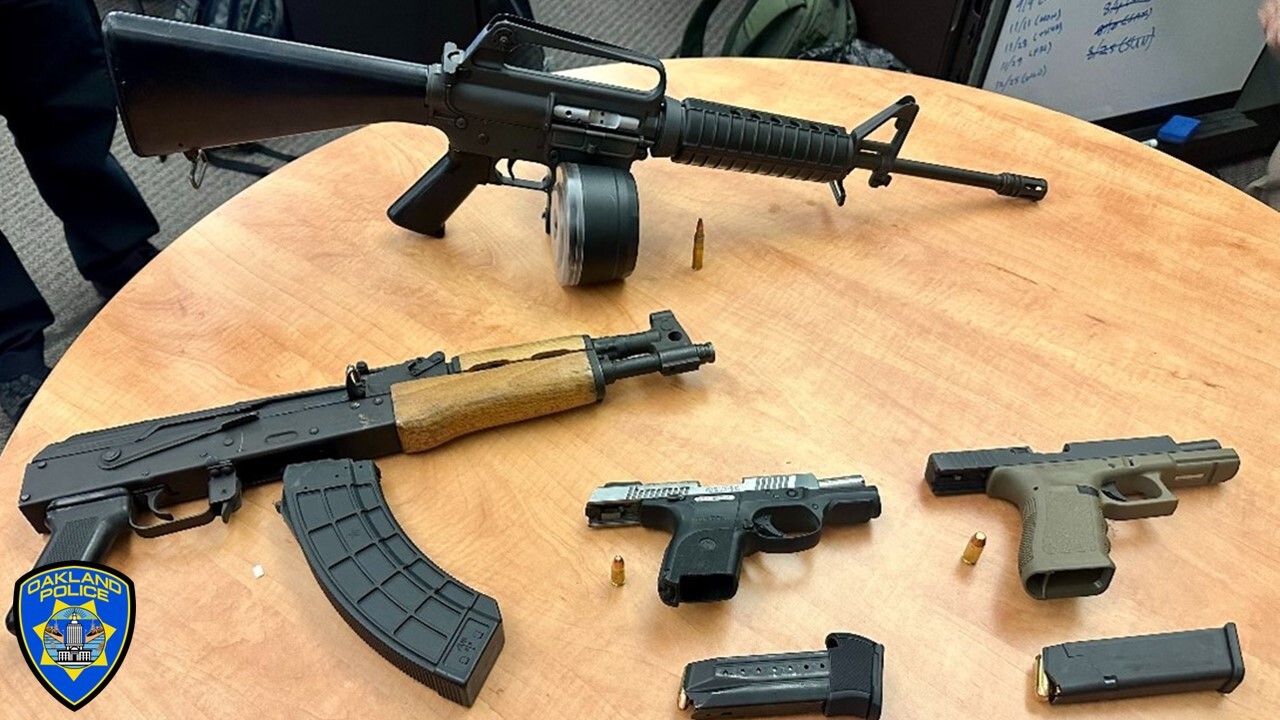 photo of multiple loaded firearms, including an AK-47 and an AR-15, both high-capacity rifles.