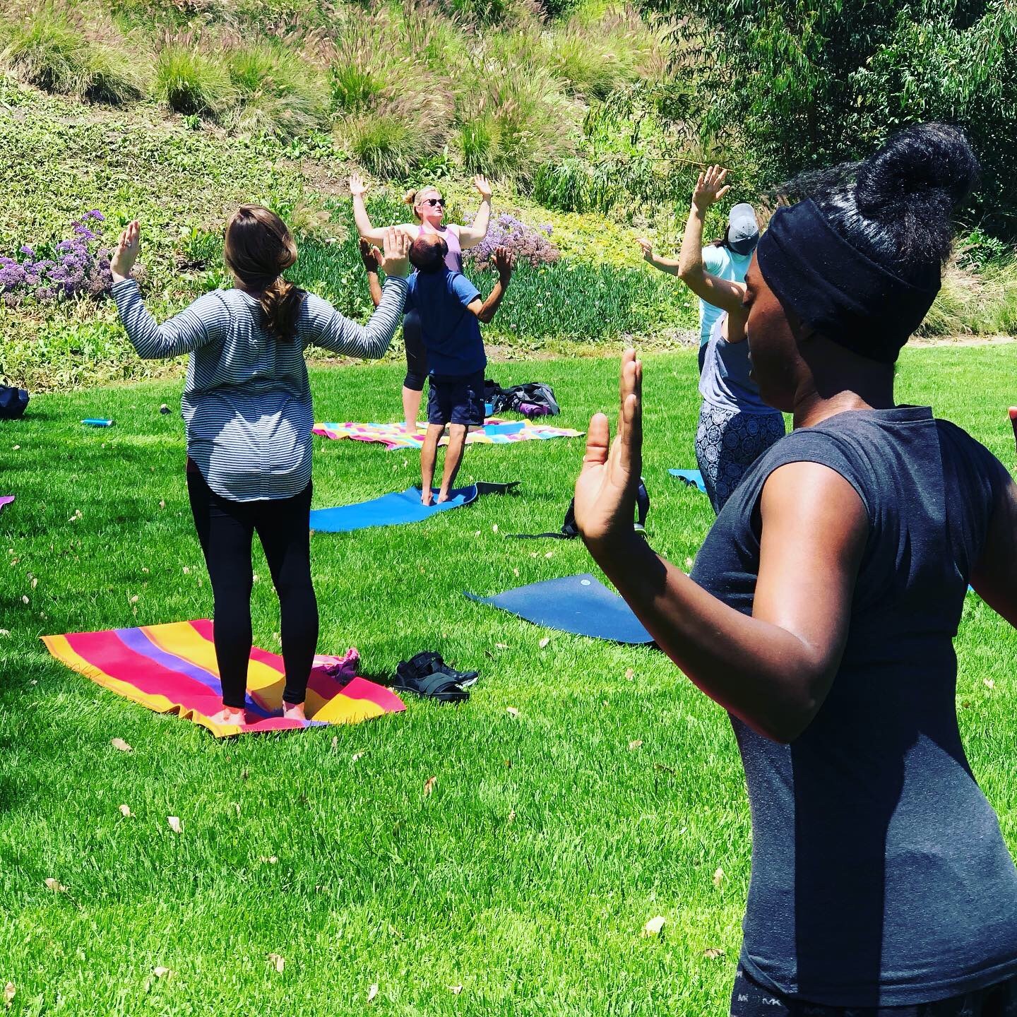 people doing yoga in the grass