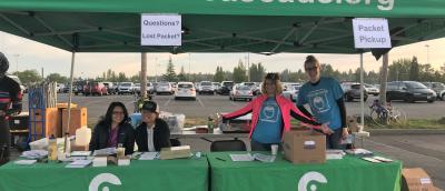 Volunteers at a packet pickup tent the morning of STP