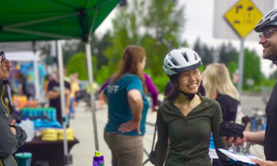 Two riders visit an outdoor rider support station on Bike Everywhere Day.