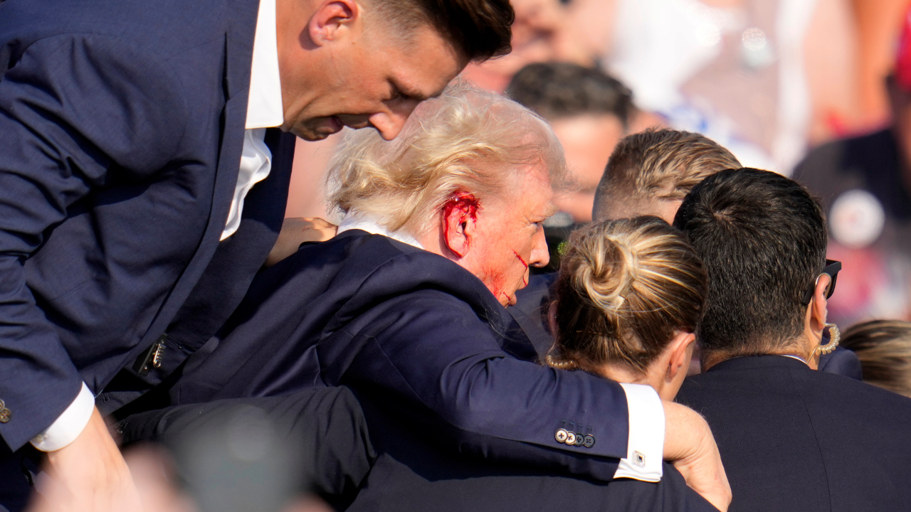 Republican presidential candidate former President Donald Trump is helped off the stage at a campaign event in Butler, Pa., on Saturday, July 13, 2024.