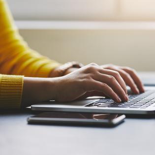 Person typing on laptop