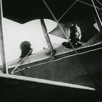 Still from the film Deliverance, 1919. The story of Helen Keller and Anne Sullivan. View shows Keller in the cockpit/front seat of an airplane.