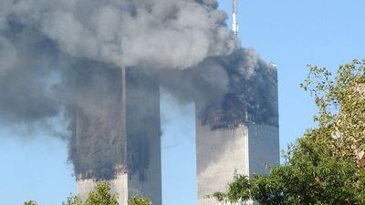 Clouds of smoke rise from fires at the World Trade Center Towers as a result of terrorist attack on September 11, 2001. Photographed 9:54 am in Lower Manhattan.