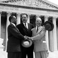 George E.C. Hayes, left, Thurgood Marshall, center, and James M. Nabrit join hands as they pose outside the U.S. Supreme Court in Washington, D.C., May 17, 1954. The three lawyers led the fight for abolition of segregation in public schools before the....