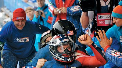 Former U.S. Army World Class Athlete Program bobsledder Steven Holcomb, front, is greeted at the finish line after teaming with Justin Olsen, Steve Mesler and Curtis Tomasevicz to win the first Olympic bobsleigh gold medal in 62 years for Team USA ,(cont)