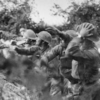 American troops at the front in Italy. American soldiers on the Piave (river) front hurling a shower of hand grenades into the Austrian trenches, Varage, Italy; September 16, 1918. (World War I)