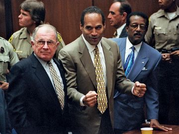 O.J. Simpson reacts as he is found not guilty of murdering his ex-wife Nicole Brown Simpson and her friend Ron Goldman at the Criminal Courts Building in Los Angeles Oct. 3, 1995. Defense lawyer F. Lee Bailey (l), defense attorney Johnnie Cochran Jr. (r)