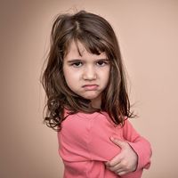 Frowning little girl. Angry annoyed