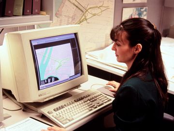 Computer mapping, woman at early 1990s computer