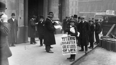 Newspaper boy Ned Parfett sells copies of the Evening News telling of the Titanic maritime disaster, outside Oceanic House, the London offices of the Titanic's owner, the White Star Line, in Cockspur Street, London, April 16, 1912.