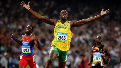 Usain Bolt of Jamaica reacts after breaking the world record with a time of 19.30 to win the gold medal as Churandy Martina (left) of Netherlands Antilles and Brian Dzingai of Zimbabwe come in after him in the Men's 200m Final at the National Stadium during Day 12 of the Beijing 2008 Olympic Games on August 20, 2008 in Beijing, China. (Summer Olympics, track and field, athletics)