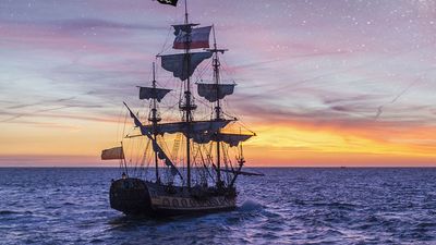 Pirate Ship leaving the harbor at the milky way sunset for a long campaign against the loyal marines on the oceans