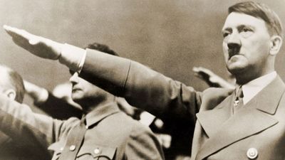 Adolf Hitler, giving Nazi salute. To Hitler's right is Rudolph Hess. 1939.