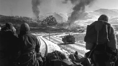 Korean War - U.S. Marines watch explosions of bombs dropped by Marine Vought F4U Corsair fighter bomber planes during the Battle of Chosin Reservoir, Korea, in December 1950. soldiers