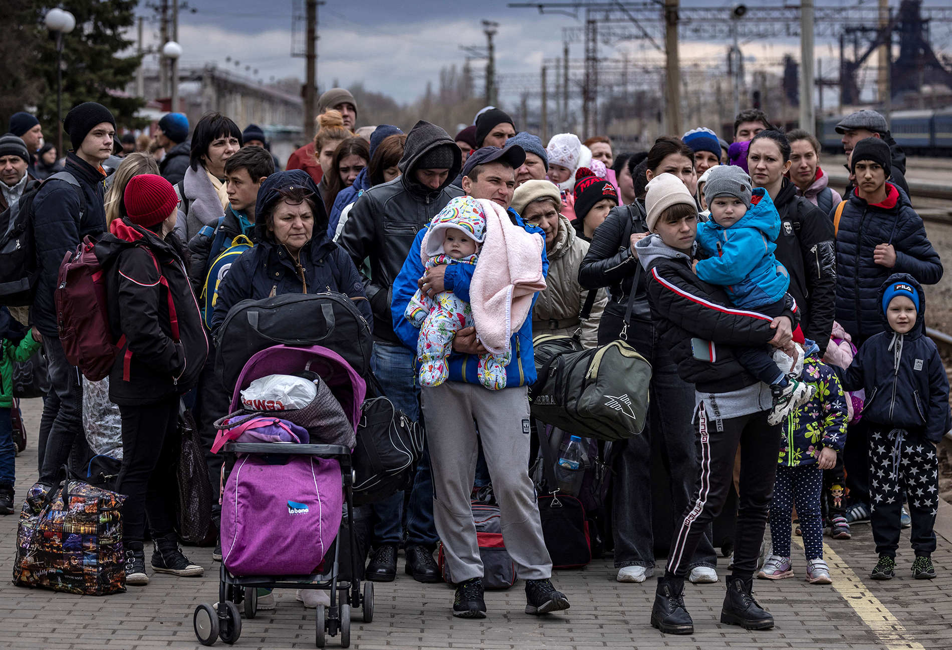 KRAMATORSK, UKRAINE: Families flee Russia’s invasion of the Donbas region in April 2022.