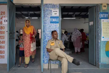 A woman leaves after casting her vote at a polling station during the sixth phase of the general election, in New Delhi, India, May 25, 2024. 