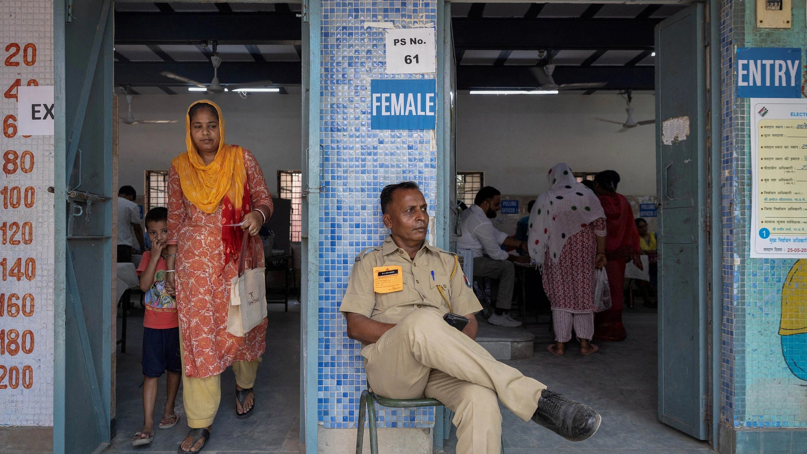 A woman leaves after casting her vote at a polling station during the sixth phase of the general election, in New Delhi, India, May 25, 2024. 