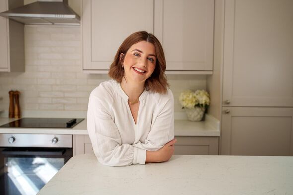 Lydia Royce poses for a picture in her kitchen