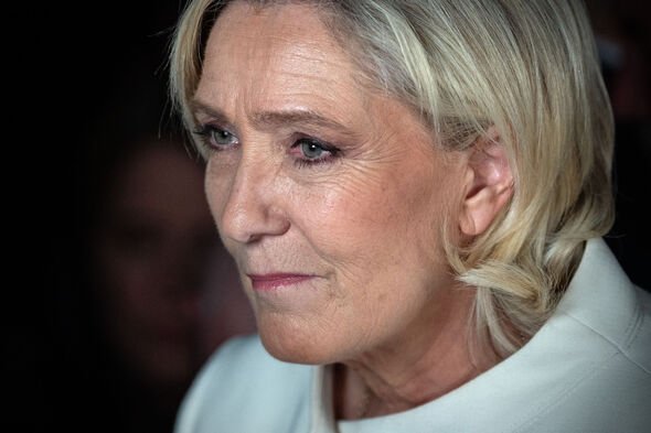 National Rally Parliamentary leader Marine Le Pen speaks to the press