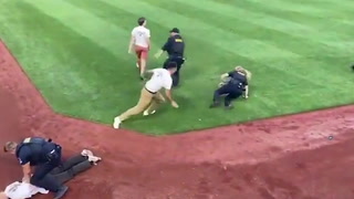 Climate activists storm baseball field and are tackled by police