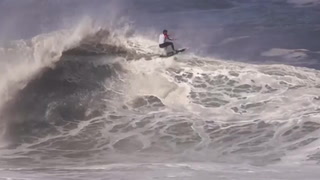 Surfers ride powerful 13ft waves amid weather warning