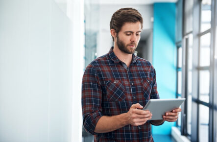 Man using a tablet to view mortgage rates