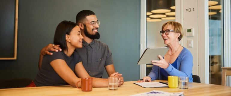 Couple securing a mortgage in principle with a financial adviser