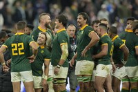 South African players celebrate after they won the Rugby World Cup quarterfinal match between France and South Africa at the Stade de France in Saint-Denis, near Paris on Oct. 15, 2023. (AP Photo/Christophe Ena)