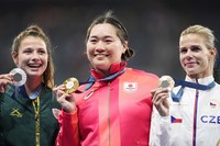 Japan's Haruka Kitaguchi, center, poses with her javelin gold medal at the Paris Olympics on Aug. 10, 2024, at Stade de France in Saint-Denis, just outside of Paris, alongside South Africa's Jo-Ane van Dyk, left, and the Czech Republic's Nikola Ogrodnikova, who took silver and bronze, respectively.