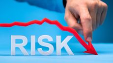 The word risk on a blue background with a red line across the top with an arrow facing down at the end.
