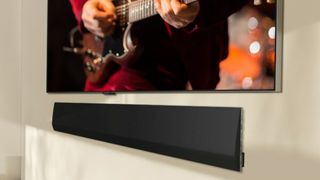 LG wall mounted 2024 soundbar underneath a TV