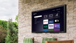 Roku TV homescreen displayed on a wall-mounted TV