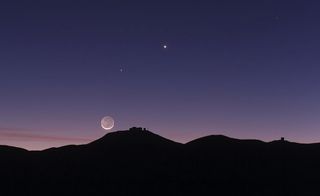 Light from Earth bounces off the moon above the Paranal Observatory in Chile.