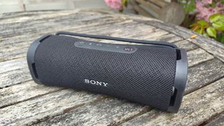 Sony ULT Field 1 wireless speaker on wooden outside table