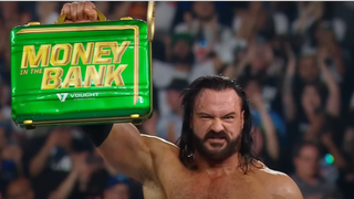Drew McIntyre hoisting the Money In The Bank briefcase