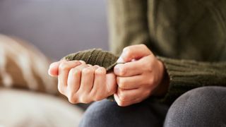 woman with anxiety pulling on her jumper