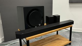 Samsung HW-Q990D soundbar system all components on wooden TV bench