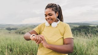 A woman checking her fitness tracker during workout