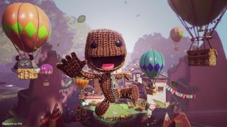 Sackboy smiling and jumping into a sky filled with hot air balloons in the PS5 game Sackboy: A Big Adventure.