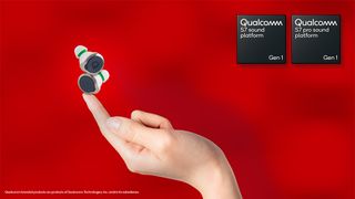 A pair of wireless earbuds balancing on a fingertip in front of a red background alongside Qualcomm S7 branding.