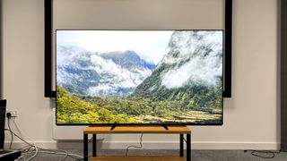 Sony Bravia 9 Mini LED TV on wooden TV rack showing mountains and clouds on screen