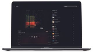 Tidal's playback and queue interface displayed on a MacBook Pro laptop