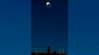 A marriage proposal beneath totality of a solar eclipse.