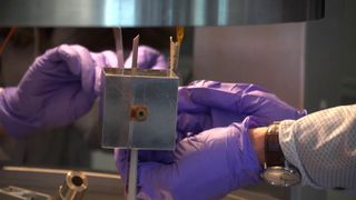 Scientists' hands holding lab equipment