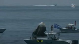 Private boaters, one bearing a Trump flag, approach close to SpaceX's Demo-2 Crew Dragon capsule carrying NASA astronauts Bob Behnken and Doug Hurley shortly after its splashdown in the Gulf of Mexico off the Pensacola, Florida coast on Aug. 2, 2020.