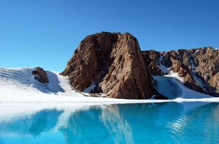 Ice lake or supraglacial lake. Surface melt water can pond on the surface of the glacier forming large lakes that can drain catastrophically. Belcher Glacier, Devon Island, Nunavut, Canada.