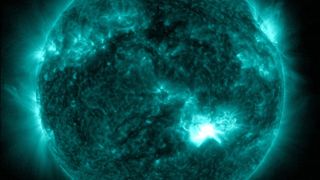 A bright flash on the sun showing where a solar flare erupted