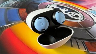 Google Pixel Buds Pro in-ear headphones in case on colourful album cover